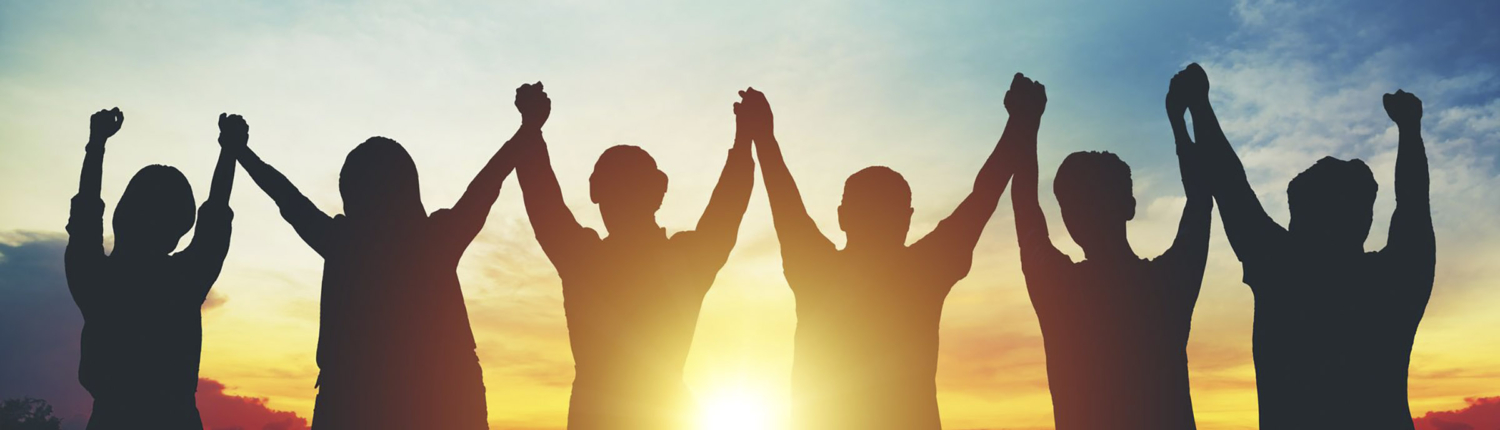Silhouette of group business team making high hands over head in sunset sky